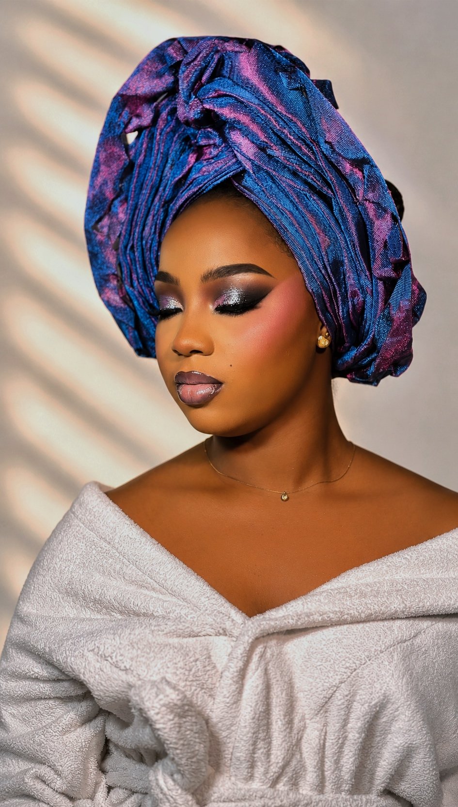 Glam makeup by glamby_meemah, model in a jewel-toned headwrap with smoky eye and gloss lip