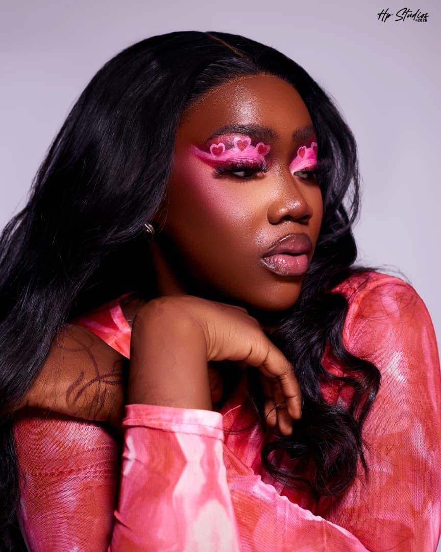 Glam makeup by glamby_meemah, bold pink heart eyeshadow look against a lilac backdrop